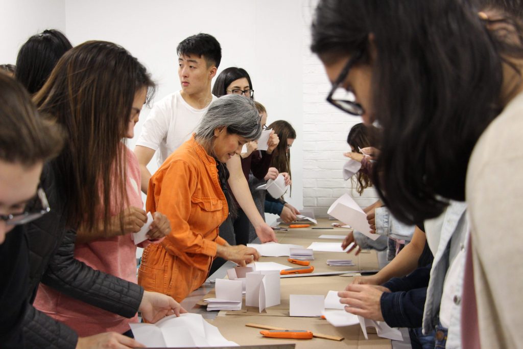 students at work on long table