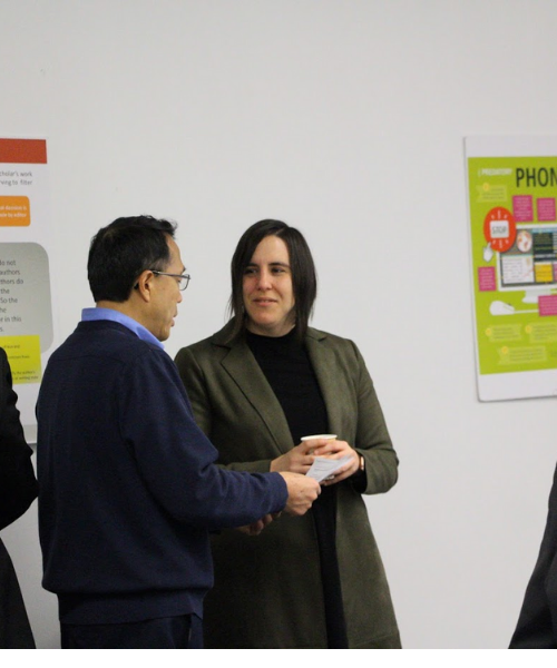 Sarah Weaver talking with library staff member at the launch