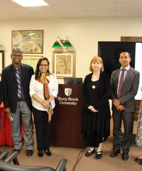 Presenters posing in front of podium