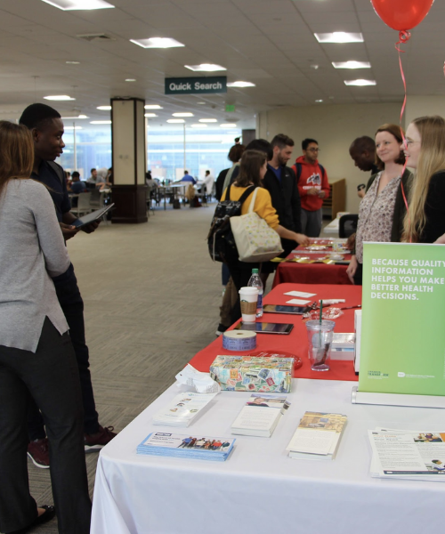 Row of tables with representatives of different companies